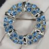 BRO-00001 (2) Light Blue Rhinestone Wreath Brooch | Silver Tone