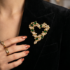 Monet Green and Clear Rhinestone Open Heart Brooch in Gold Tone